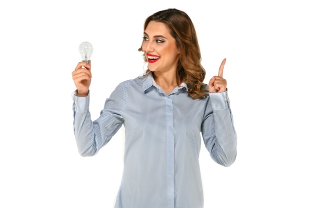 Beautiful, happy girl looking to the side on bulb with raised forefinger