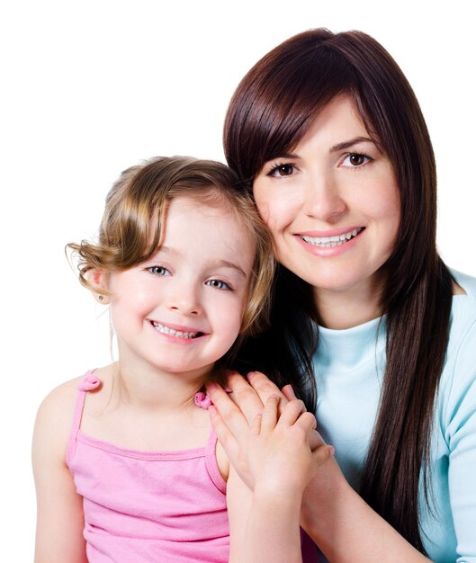 Beautiful happy mother with little pretty smiling daughter