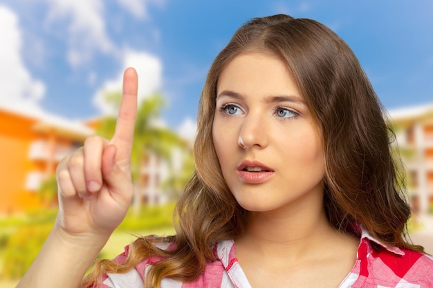 Beautiful happy smiling woman pointing up