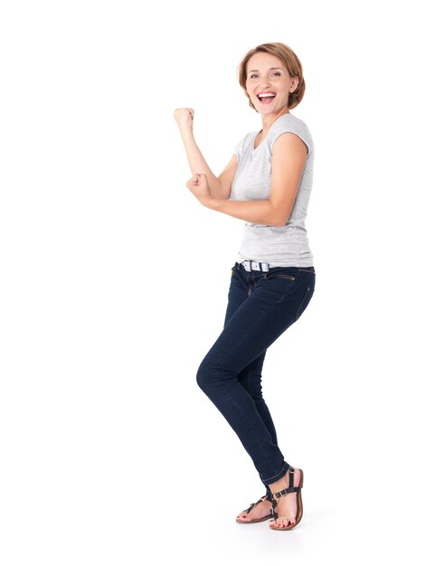 Beautiful happy woman celebrating success being a winner with dynamic energetic expression isolated on white