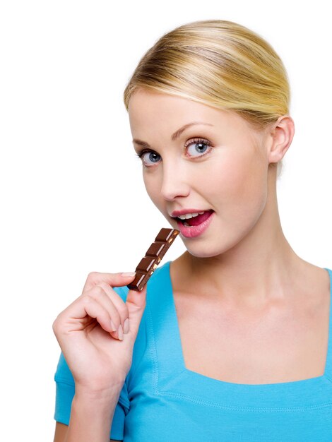 Beautiful happy woman with slice of the  black chocolate - isolated on white
