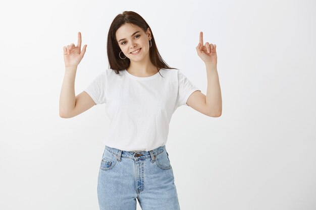 Beautiful healthy young woman posing against white wall