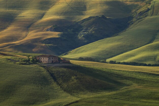 Beautiful high angle shot of a building on top of the grassy hill