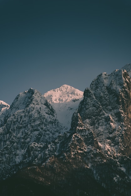 Beautiful high rocky mountains with a snowy mountain in between