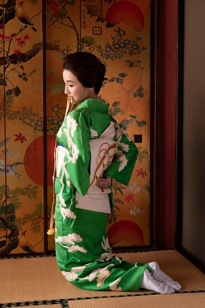 Beautiful japanese woman putting on an obi