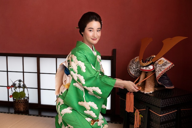 Free photo beautiful japanese woman next to traditional object