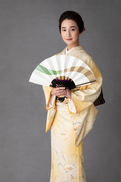 Beautiful japanese woman with a minimalist hand fan