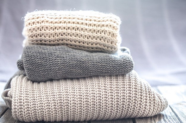 beautiful knitted clothes, neatly folded, close-up, handmade sweaters.