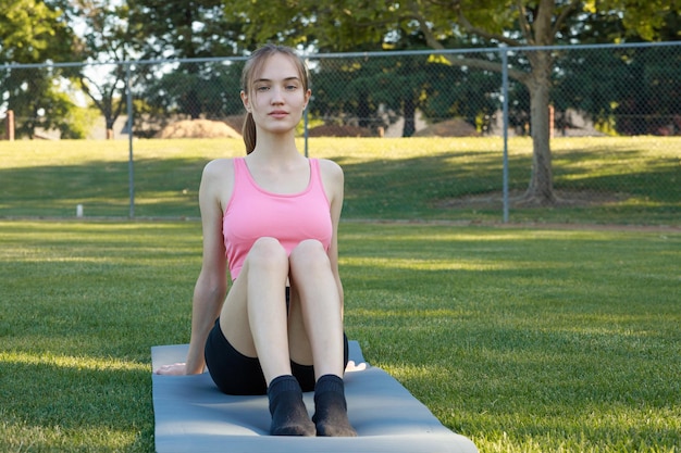 Beautiful lady standing at the park and looking to the camera