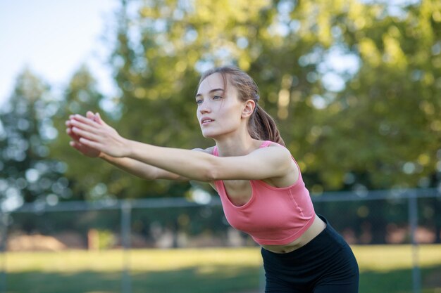 Beautiful lady standing at the park and looking to the camera