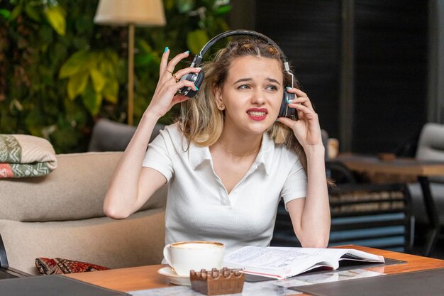 Beautiful lady trying to wear headphones