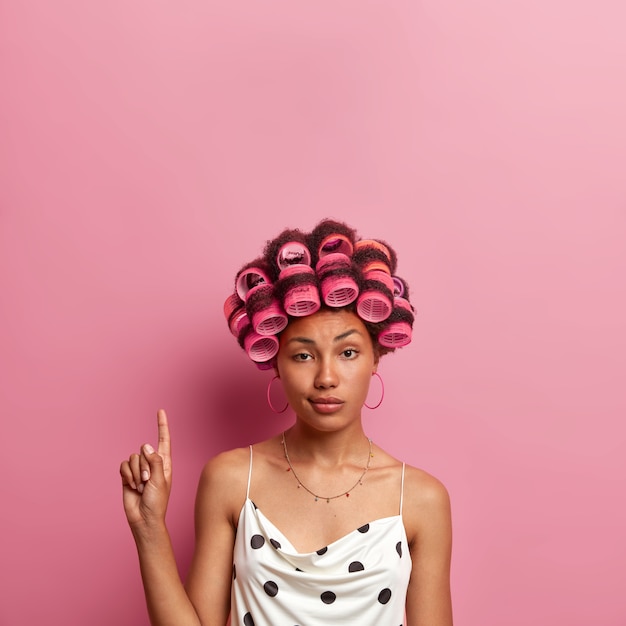 Free photo beautiful lady wearing hair curlers isolated