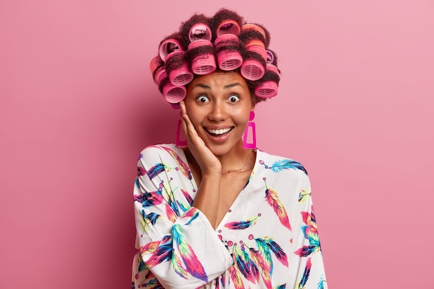 Free photo beautiful lady wearing hair curlers isolated