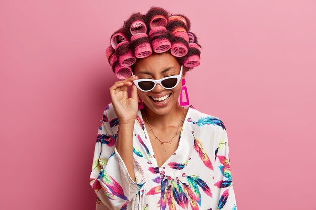 Beautiful lady wearing hair curlers isolated