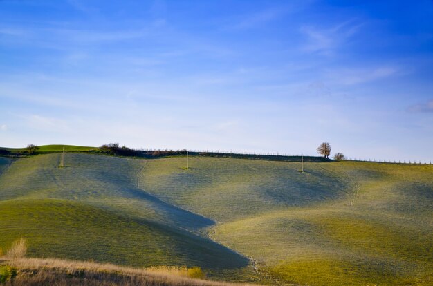 Beautiful landscape of green rolling hills under a clear blue sky