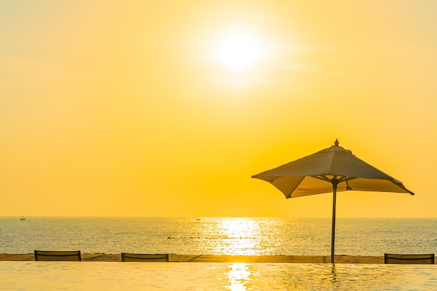 Beautiful landscape outdoor swimming pool with umbrella and deck chair in hotel resort for relax tra