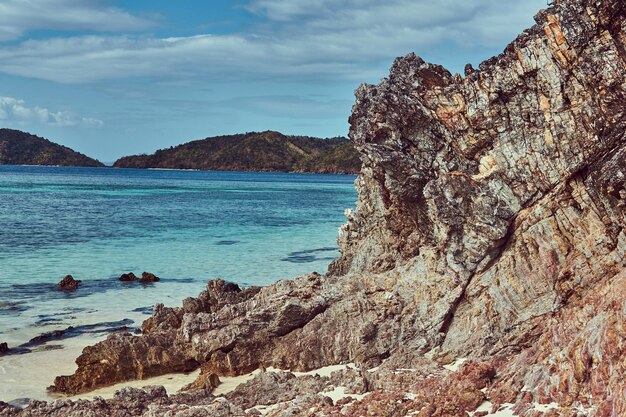 Beautiful landscape rocky stalactite reefs on the shore of Philippine Islands, Pacific ocean.