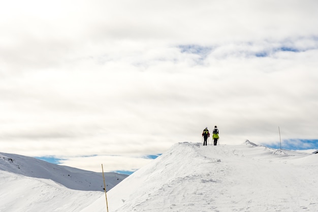 Beautiful landscape with hikers on a snowy summit in South Tyrol, Dolomites, Italy