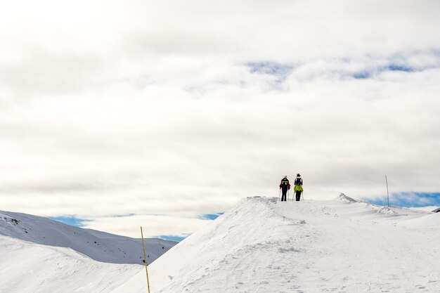 Beautiful landscape with hikers on a snowy summit in South Tyrol, Dolomites, Italy