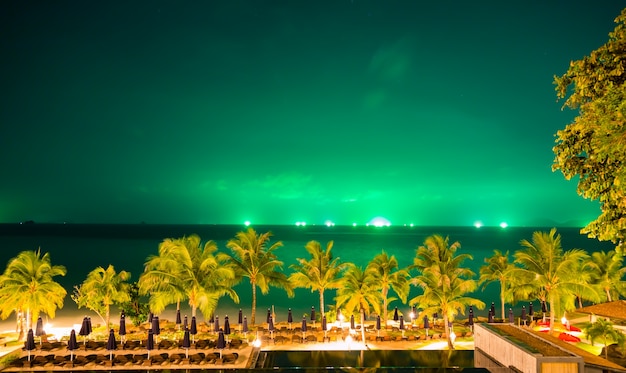 Beautiful landscape with palm trees and green sky