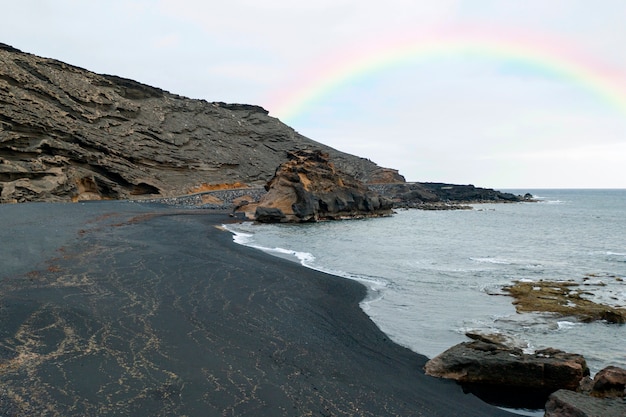 Free photo beautiful landscape with rainbow and beach