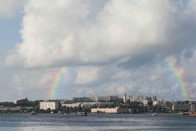 Beautiful landscape with rainbow and city