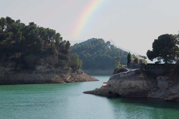 Free photo beautiful landscape with rainbow and water