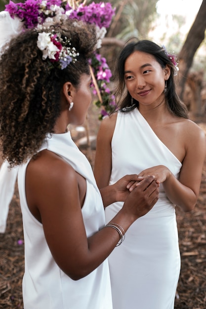 Beautiful lesbian couple celebrating their wedding day outdoors