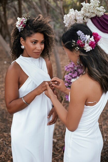 Beautiful lesbian couple celebrating their wedding day outdoors