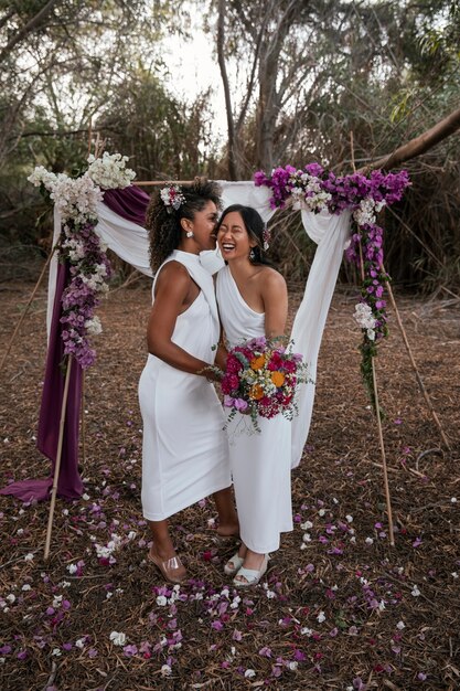 Beautiful lesbian couple celebrating their wedding day outdoors