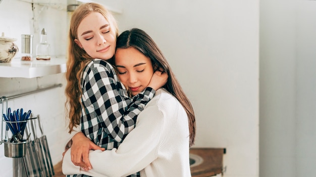 Beautiful lesbian couple embracing tenderly