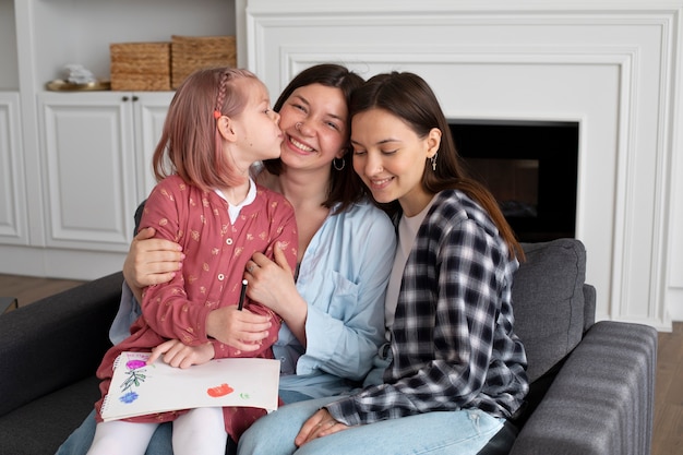 Free photo beautiful lesbian couple with their daughter