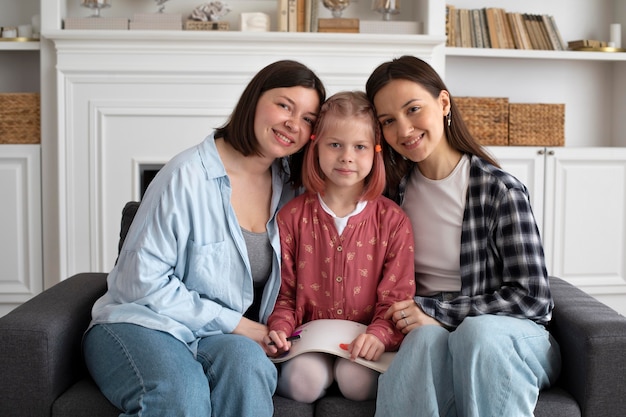 Free photo beautiful lesbian couple with their daughter