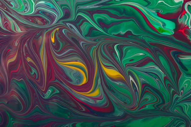 Beautiful liquid texture of the nail polish.green and purple colors.multicolored background with copy space.fluid art,pour painting technique.good as digital decor.