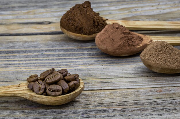 A beautiful little wooden spoon with coffee on wood different angle, closeup