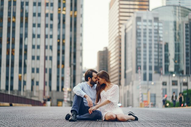 beautiful long-haired girl in summer dress with her handsome husband 