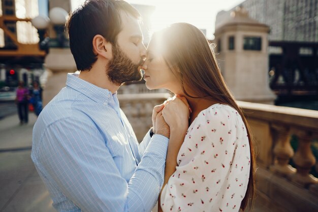 beautiful long-haired girl in summer dress with her handsome husband 