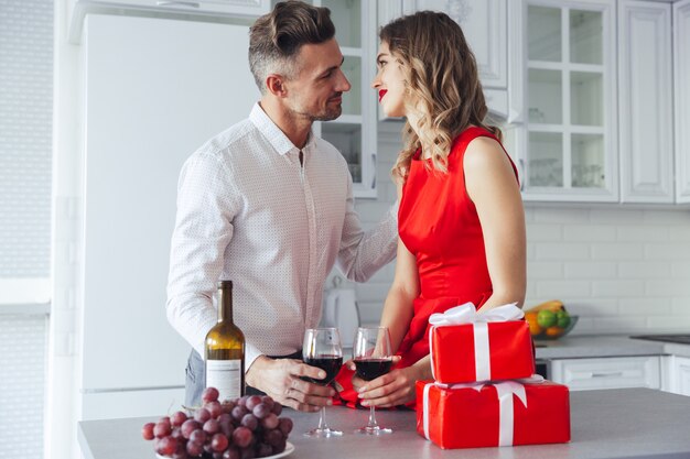 Beautiful lovers celebrating valentines day and drinking wine