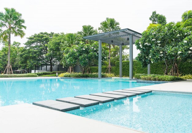 Beautiful luxury swimming pool with palm tree