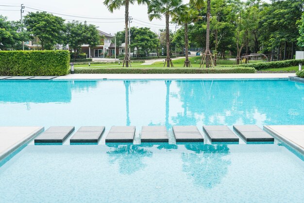 Beautiful luxury swimming pool with palm tree