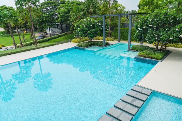 Beautiful luxury swimming pool with palm tree