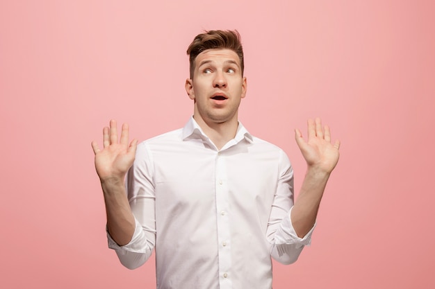 Beautiful male half-length portrait isolated on pink studio.