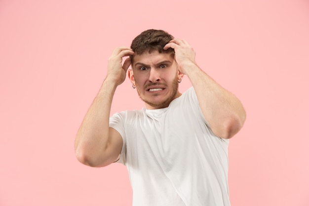 Beautiful male half-length portrait isolated on trendy pink studio