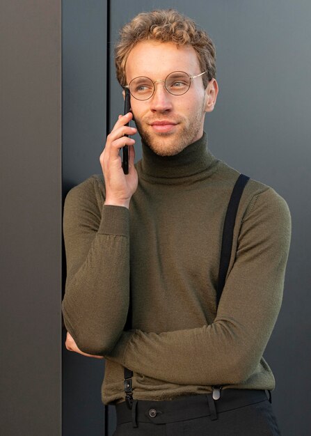 Beautiful male model talking on the phone outdoors