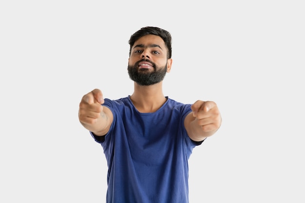 Beautiful male portrait isolated. Young emotional hindu man in blue shirt. Facial expression, human emotions. Pointing and choosing.