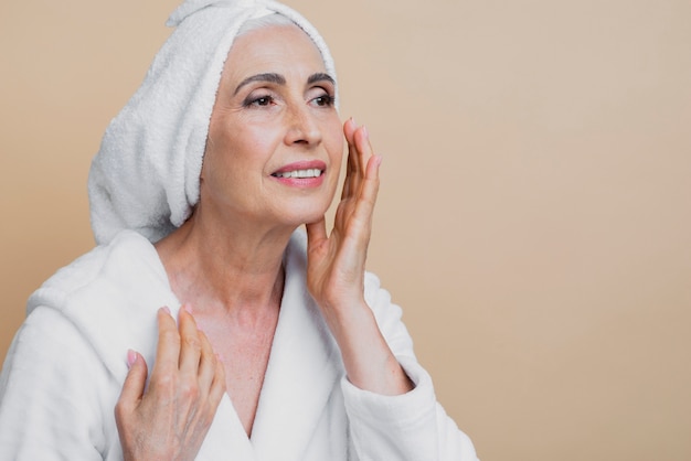 beautiful mature woman applying treatment