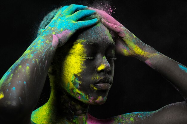 Beautiful model posing with colorful powder