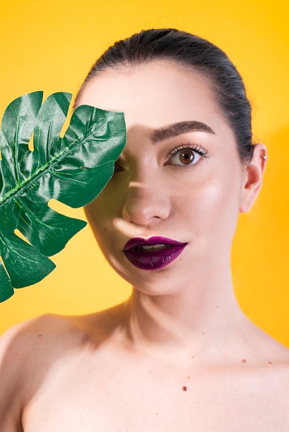 Beautiful model posing with leaf