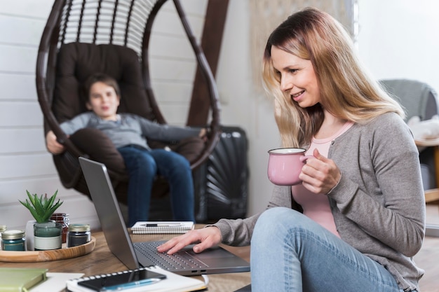 Beautiful mother enjoying working from home