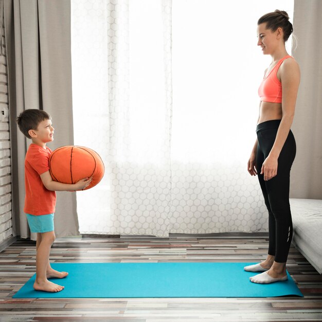 Beautiful mother exercising with her son